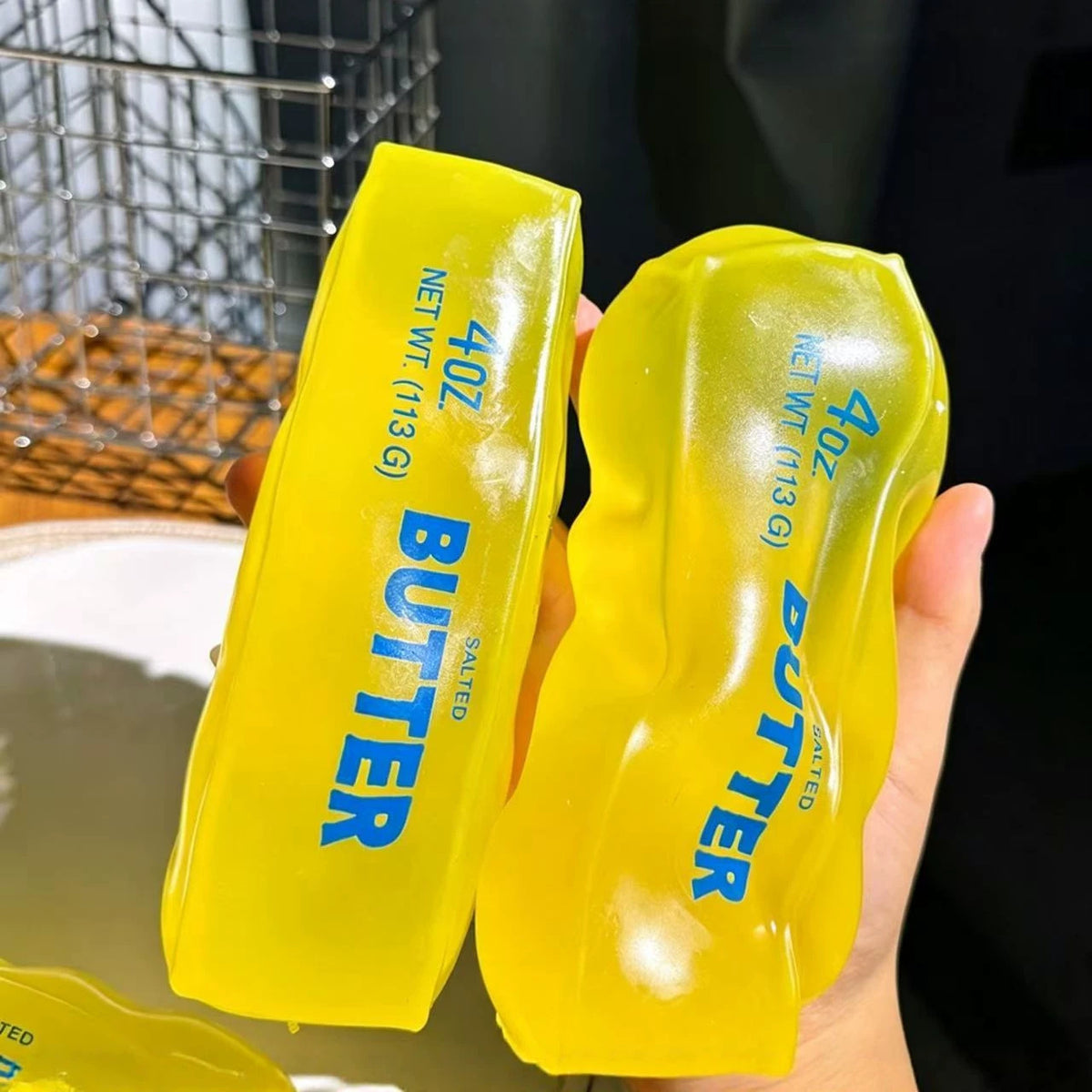 Squishyland Vaseline Butter Stick squishy toy, moldable and stress-relief fidget ball with a soft, buttery yellow appearance.